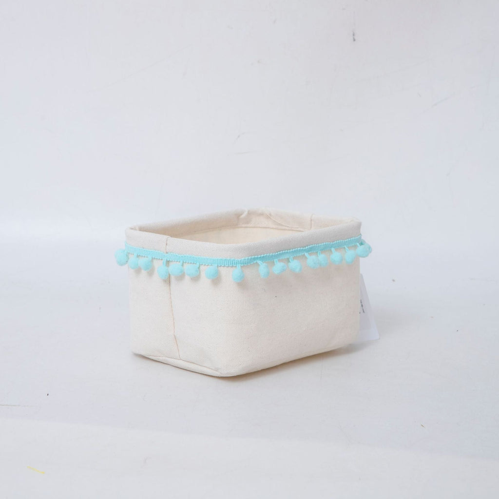 Storage basket with decorative pom-pom trim