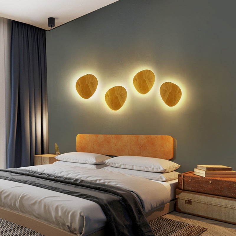 Organic pebble-shaped LED wall sconce solid wood face warm ambient backlight Siopsrl
