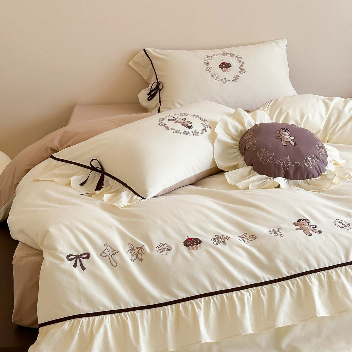 Embroidered bedding set with ruffled trim, teddy design and decorative pillow
