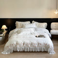 Lightly washed cotton bedding set with ruffled border and fine floral embroidery
