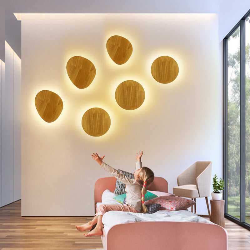 Organic pebble-shaped LED wall sconce solid wood face warm ambient backlight Siopsrl