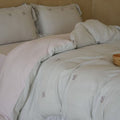 Quilted bedding set made of cotton blend with gingham check and delicate floral embroidery