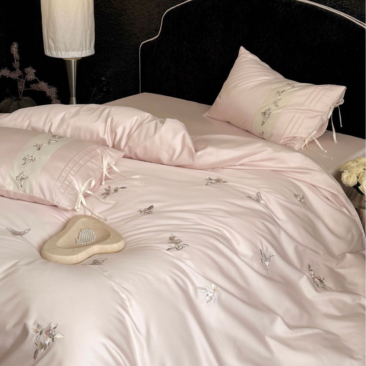 Luxurious satin bedding set with embroidered floral appliqués and bolster Bowlift