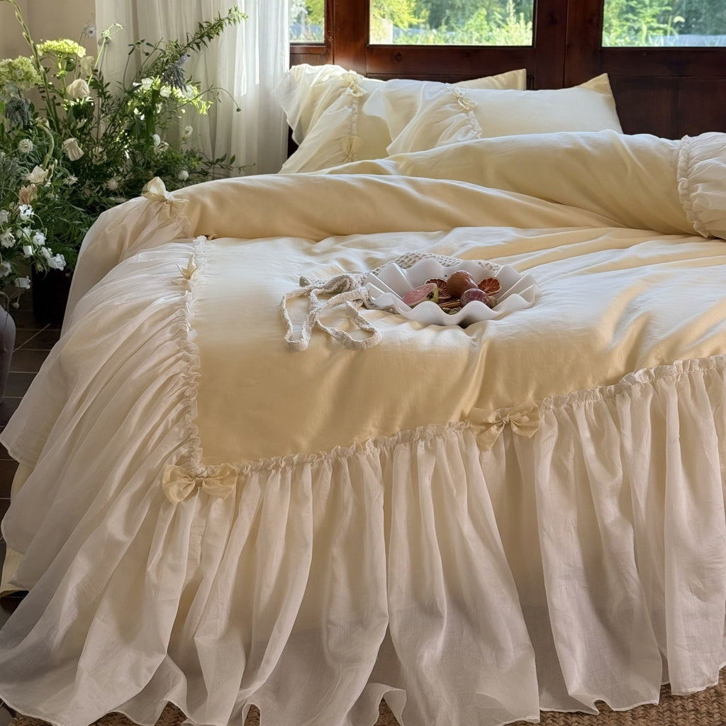 Bedding set with ruffled bed skirt, ruffle cushion and bow application