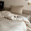 Luxurious cotton satin bedding set with delicate floral embroidery and a silky-matte surface
