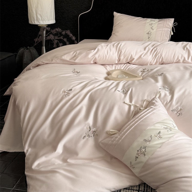 Luxurious satin bedding set with embroidered floral appliqués and bolster Bowlift