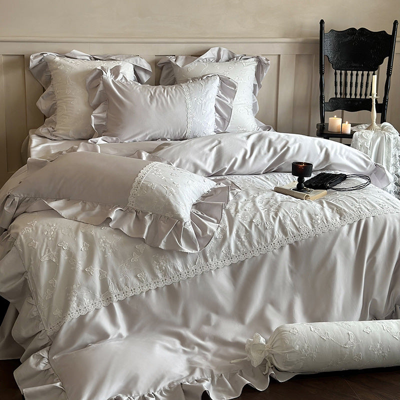 Luxurious satin bedding set with ruffles, lace trim, and fine embroidery