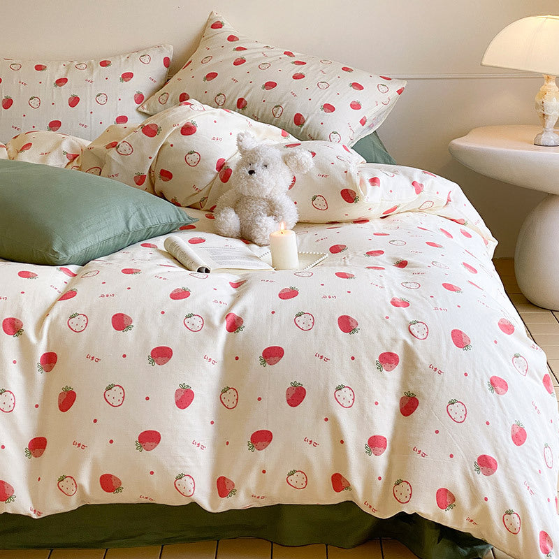 Cotton satin bedding set with playful strawberry all-over print and reversible blanket