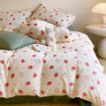 Cotton satin bedding set with playful strawberry all-over print and reversible blanket