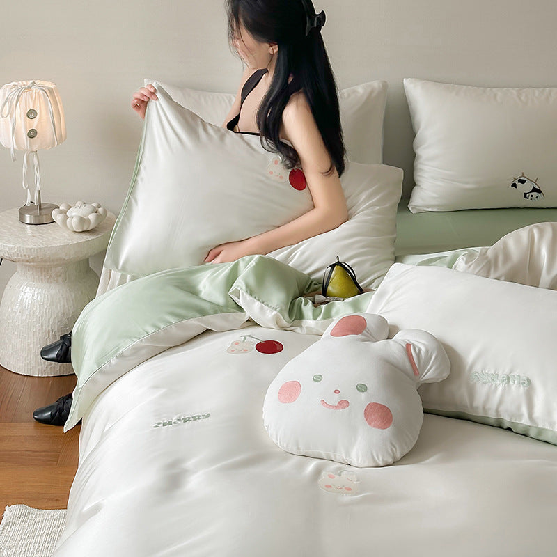 Luxurious satin bedding set with embroidered cherry motifs, reversible function and plush bunny pillow