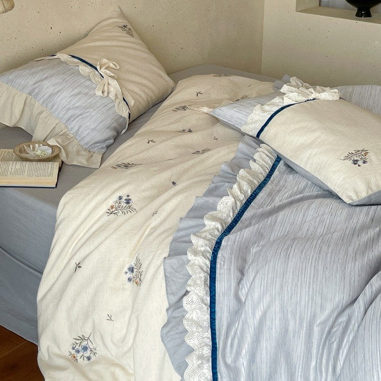 Romantic cotton satin bedding set with ruffles, embroidered flower bouquets, and decorative rolls Bowlift