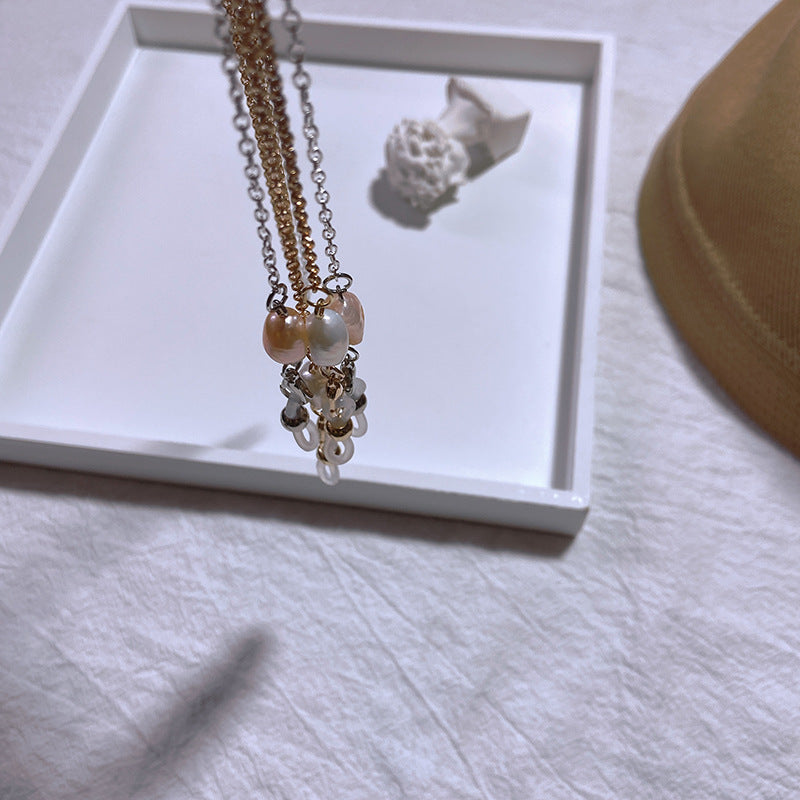Siopsrl | Elegant jewelry holder chain with pearl and gold accents Siopsrl