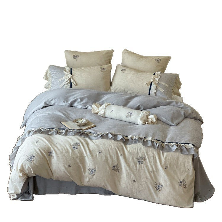 Romantic cotton satin bedding set with ruffles, embroidered flower bouquets, and decorative rolls Bowlift