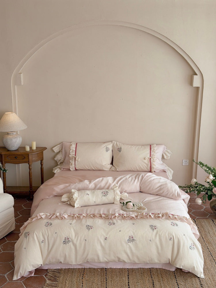 Romantic cotton satin bedding set with ruffles, embroidered flower bouquets, and decorative rolls Bowlift