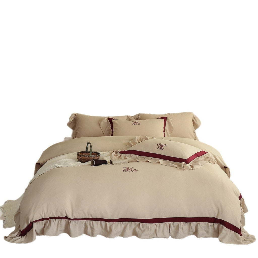 Romantic cotton-linen bedding set with ruffle, monogram embroidery, and contrasting trim Bowlift