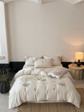 Fine satin bedding set with floral embroidery, tie ribbons and fine quilted texture Bowlift
