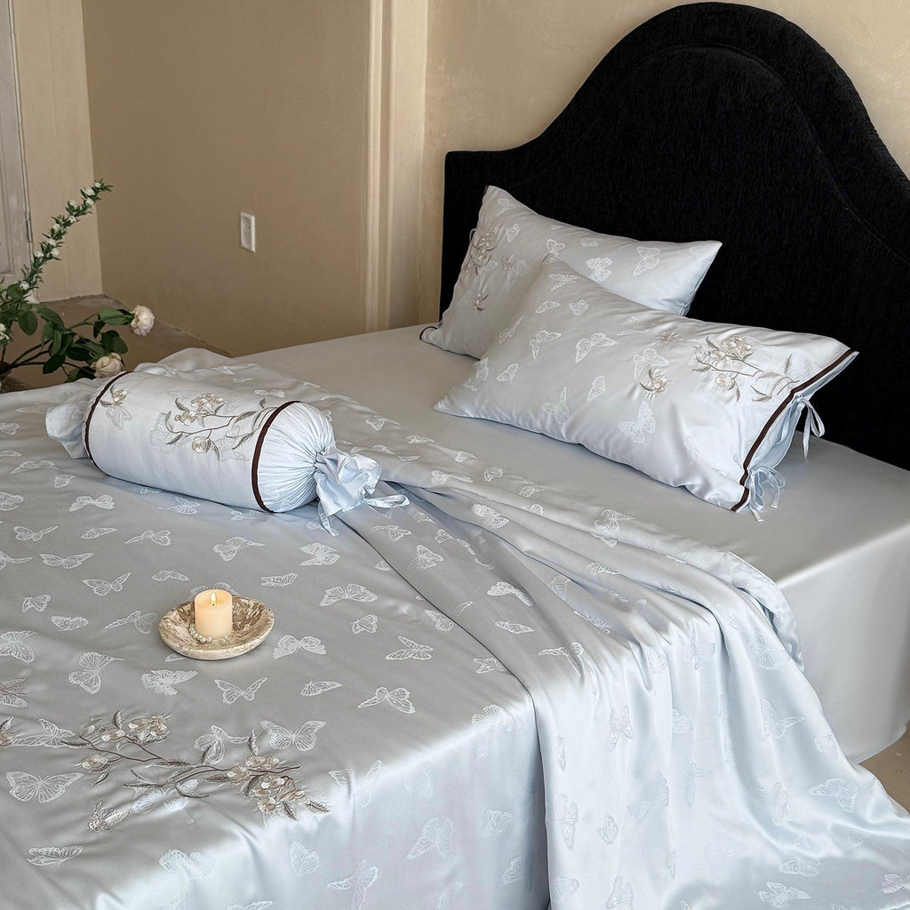 Light jacquard satin bed linen set with embroidered butterfly motif and decorative roll Bowlift