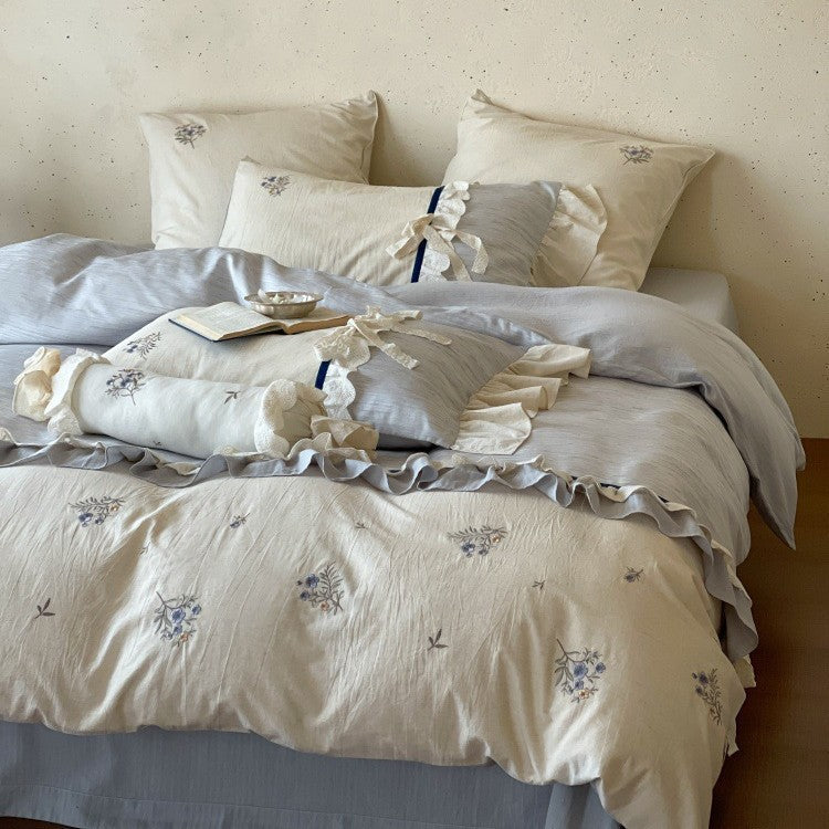 Romantic cotton satin bedding set with ruffles, embroidered flower bouquets, and decorative rolls Bowlift