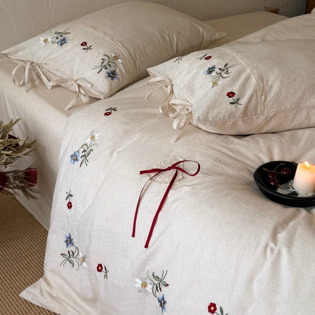 Bedding set made of linen look with floral embroidery and bow closure