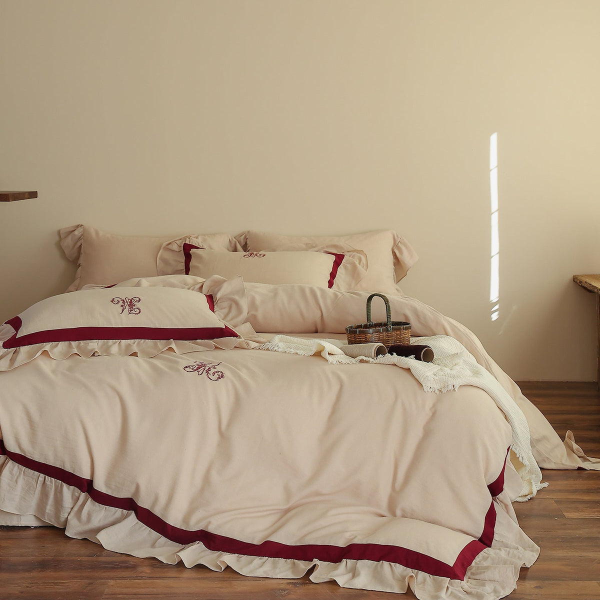 Romantic cotton-linen bedding set with ruffle, monogram embroidery, and contrasting trim Bowlift