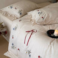 Bedding set made of linen look with floral embroidery and bow closure