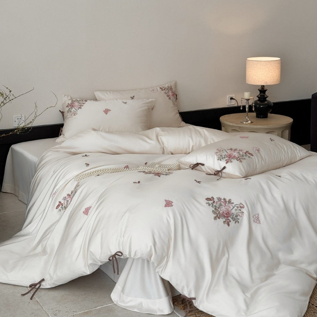 Fine satin bedding set with floral embroidery, tie ribbons and fine quilted texture Bowlift