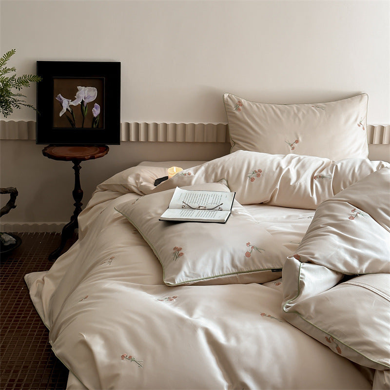 Luxurious cotton satin bedding set with delicate floral embroidery and a silky-matte surface