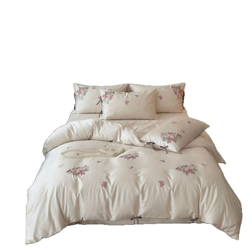 Fine satin bedding set with floral embroidery, tie ribbons and fine quilted texture Bowlift