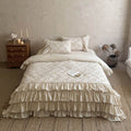 Ruffled bed linen set made of cotton quilt with stitch pattern and pillowcases