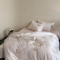 Fine glossy satin bedding set with embroidered rose bouquets and decorative pillow roll Bowlift
