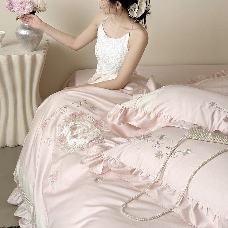 Delicate embroidered cotton satin bedding set with ruffle, satin trim, and rose motif