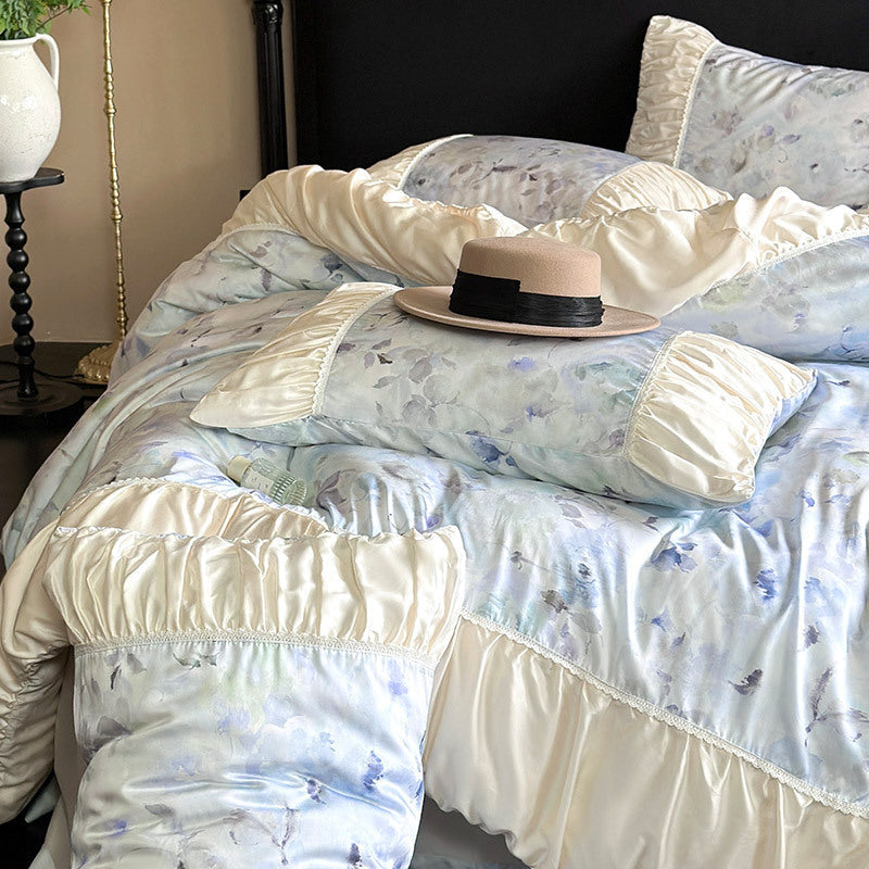 Elegant satin bedding set with watercolor floral pattern, ruffles and gathered pillowcases