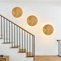 Organic pebble-shaped LED wall sconce solid wood face warm ambient backlight Siopsrl
